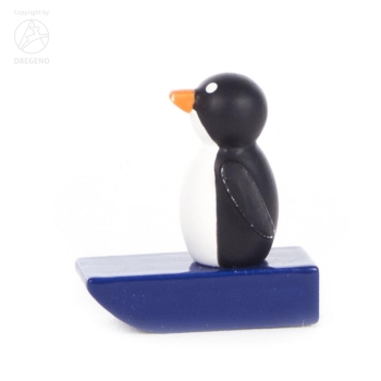 Pinguin auf blauem Schlitten